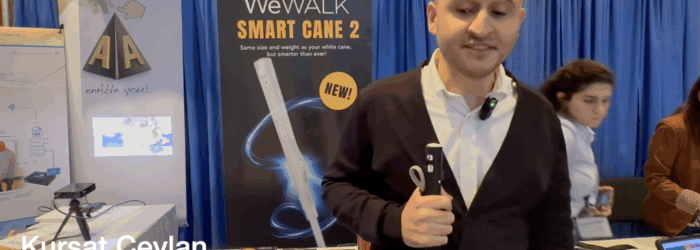 Kursat Ceylan demonstrating WeWalk Smart Cane in front of WeWalk booth at ATIA conference